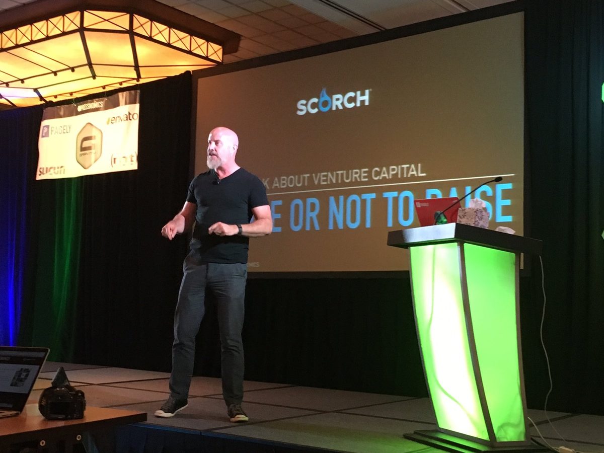 Marcus Nelson speaking on stage at a conference